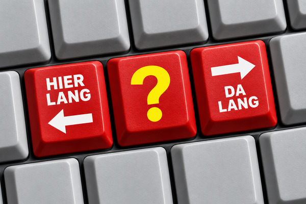 Drei rote Tastaturtasten: „HIER LANG“ mit Linkspfeil, ein gelbes Fragezeichen und „DA LANG“ mit Rechtspfeil.